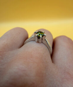 A silver ring with a natural peridot, size N