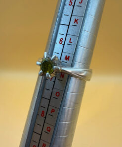 A silver ring with a natural peridot, size N