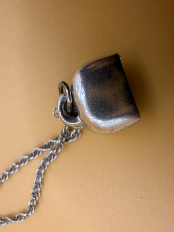 Silver bell-shaped pendant (jingles) and a Soviet-era silver chain