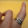 sterling silver wave ring features a distinctive intertwined design Uk size M
