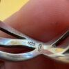 sterling silver wave ring features a distinctive intertwined design Uk size M