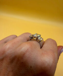 A silver ring, size M, with three large clear stones~108