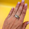 A silver ring, size M, with three large clear stones~108