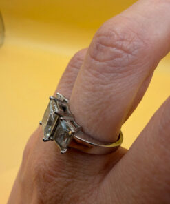 A silver ring, size M, with three large clear stones