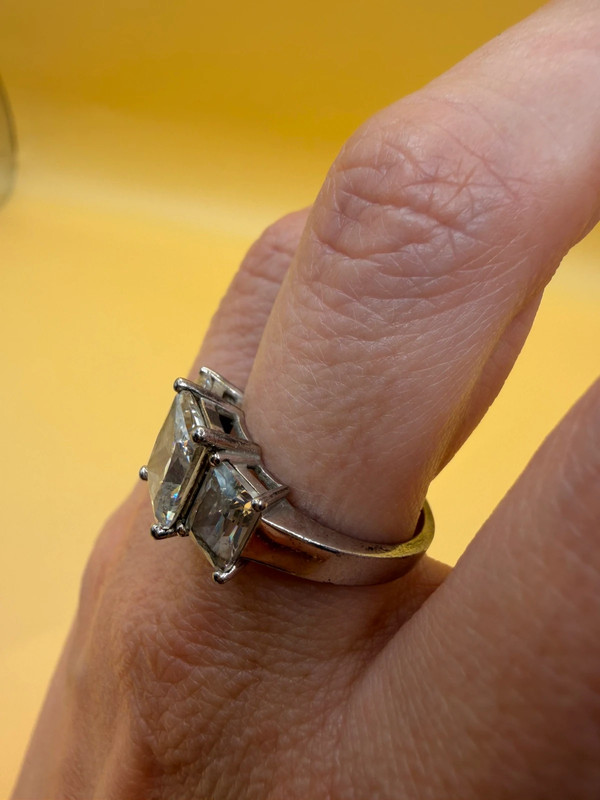 A silver ring, size M, with three large clear stones~108