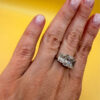 A silver ring, size M, with three large clear stones~108