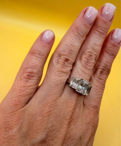 A silver ring, size M, with three large clear stones