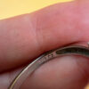 A silver ring, size M, with three large clear stones~108