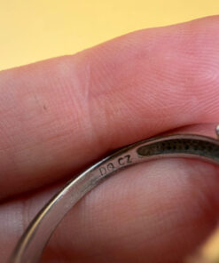 A silver ring, size M, with three large clear stones