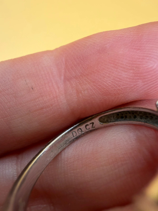 A silver ring, size M, with three large clear stones~108