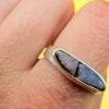 A silver ring featuring a natural opal, size Q