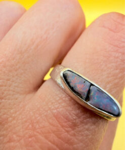 A silver ring featuring a natural opal, size Q