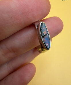 A silver ring featuring a natural opal, size Q