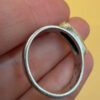 A silver ring featuring a natural opal, size Q
