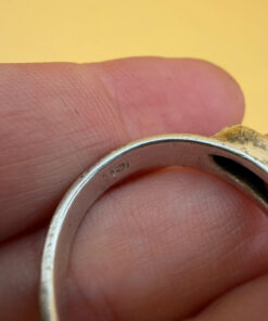 A silver ring featuring a natural opal, size Q