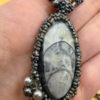 Necklace with a polished Orthoceras fossil cabochon and beads.