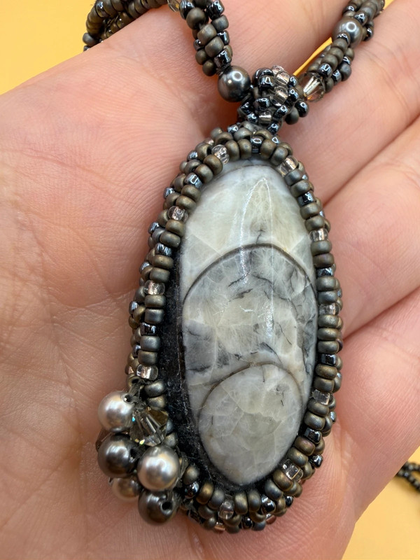 Necklace with a polished Orthoceras fossil cabochon and beads.
