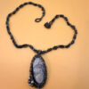 Necklace with a polished Orthoceras fossil cabochon and beads.