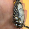 Necklace with a polished Orthoceras fossil cabochon and beads.
