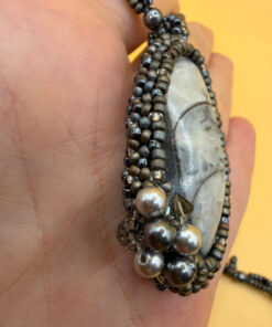 Necklace with a polished Orthoceras fossil cabochon and beads