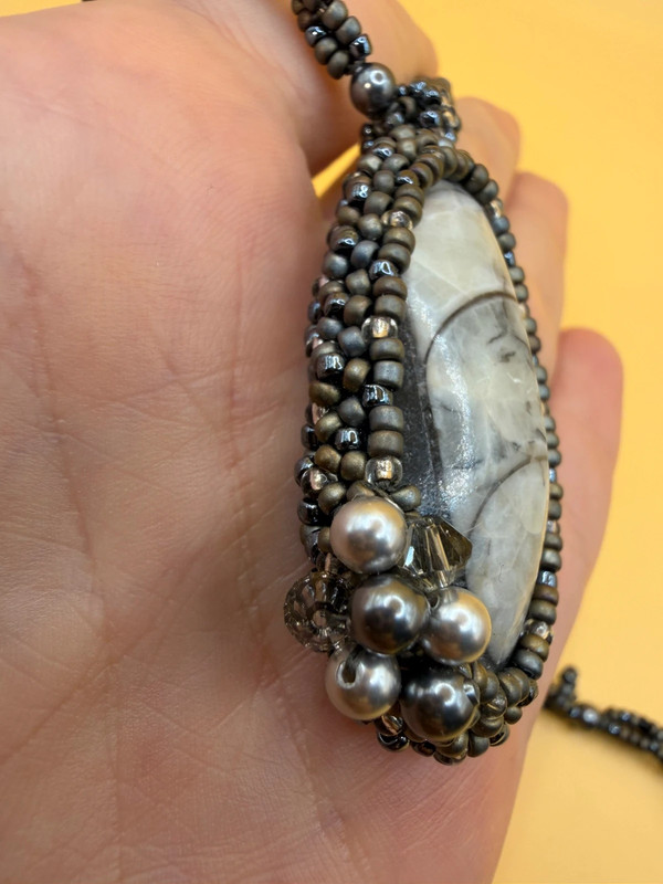 Necklace with a polished Orthoceras fossil cabochon and beads.