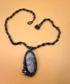 Necklace with a polished Orthoceras fossil cabochon and beads.