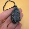 Necklace with a polished Orthoceras fossil cabochon and beads.