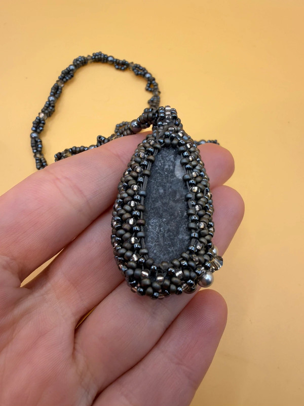 Necklace with a polished Orthoceras fossil cabochon and beads.