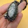 Necklace with a polished Orthoceras fossil cabochon and beads.
