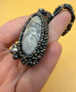 Necklace with a polished Orthoceras fossil cabochon and beads