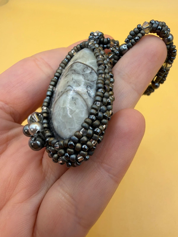 Necklace with a polished Orthoceras fossil cabochon and beads.