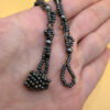 Necklace with a polished Orthoceras fossil cabochon and beads.