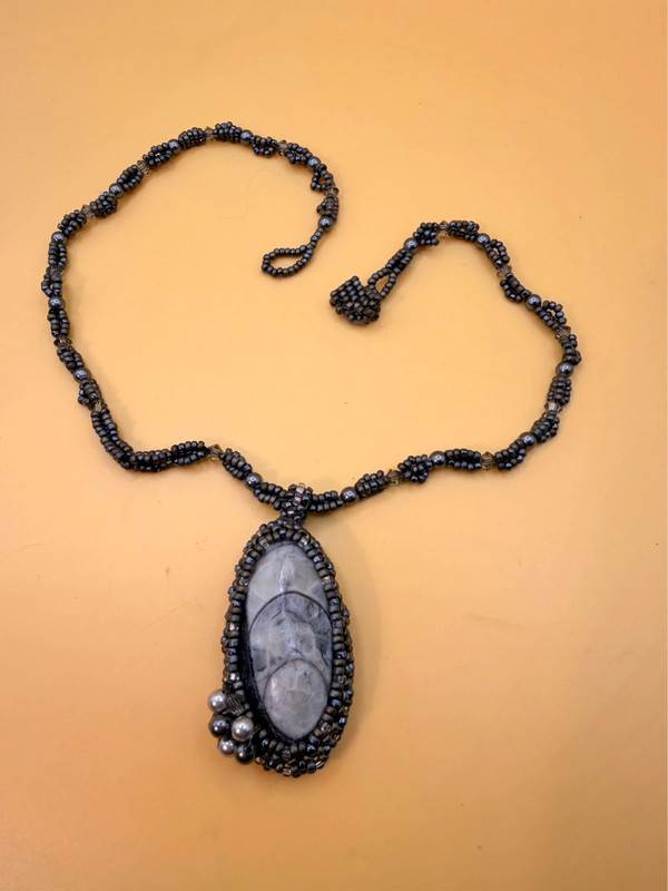 Necklace with a polished Orthoceras fossil cabochon and beads.