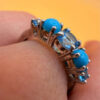 A silver ring, size P, with natural topaz and turquoise stones