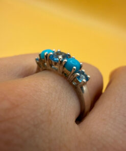 A silver ring, size P, with natural topaz and turquoise stones