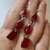 Vintage sterling silver earrings set with natural red coral cabochons.