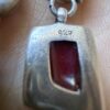 Vintage sterling silver earrings set with natural red coral cabochons.