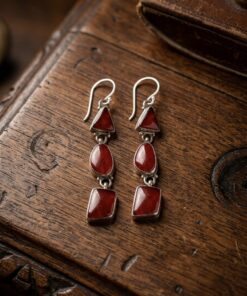 Vintage sterling silver earrings set with natural red coral cabochons.