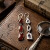 Vintage sterling silver earrings set with natural red coral cabochons.