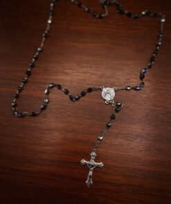 Vintage Italian rosary, c. 1950s–1970s. Five decades of black faceted Czech glass beads with an aurora borealis finish